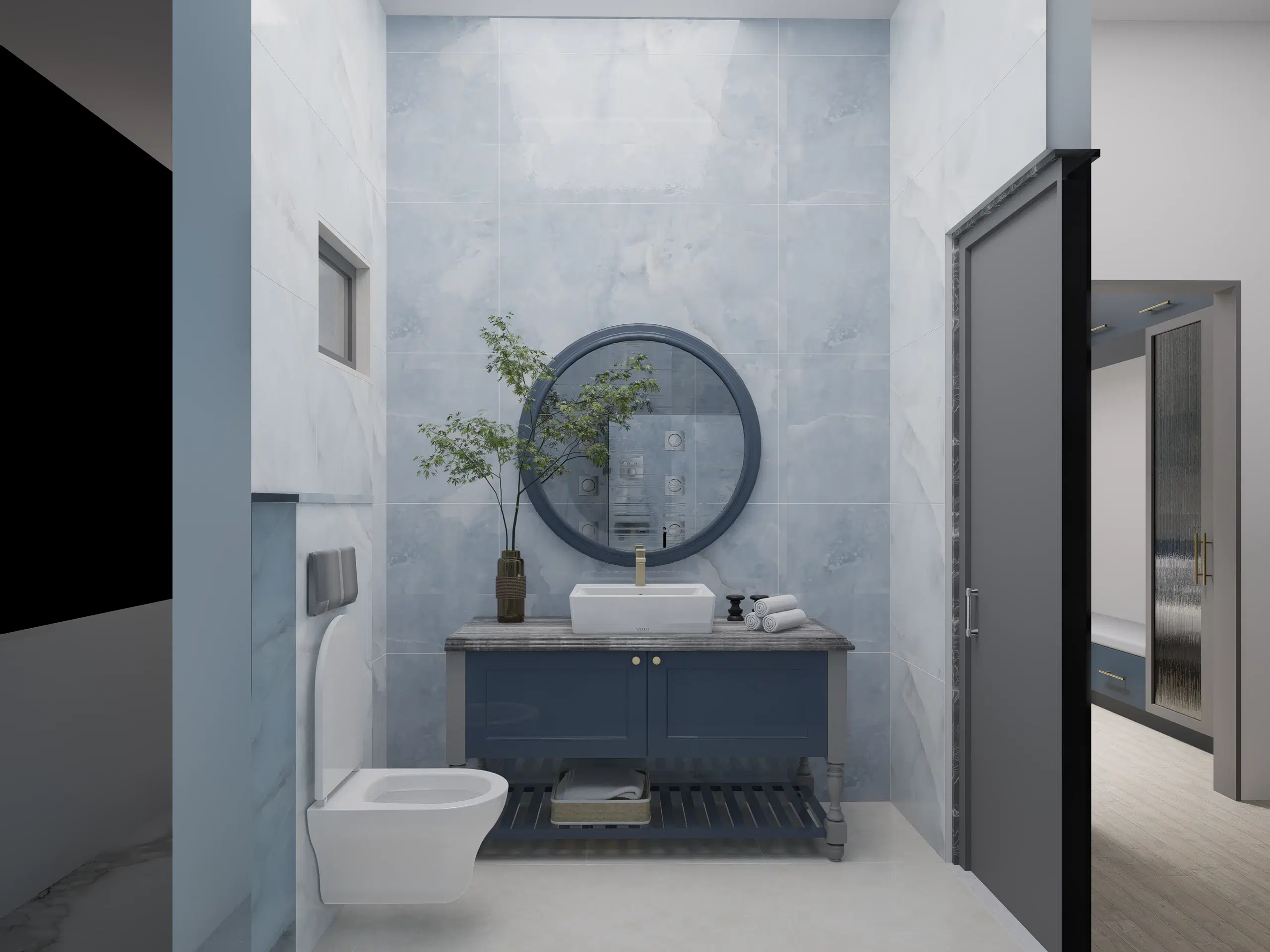 Fortune enclave, Balaji nagar — the bathroom, a round mirror over a navy vanity against pale marble.