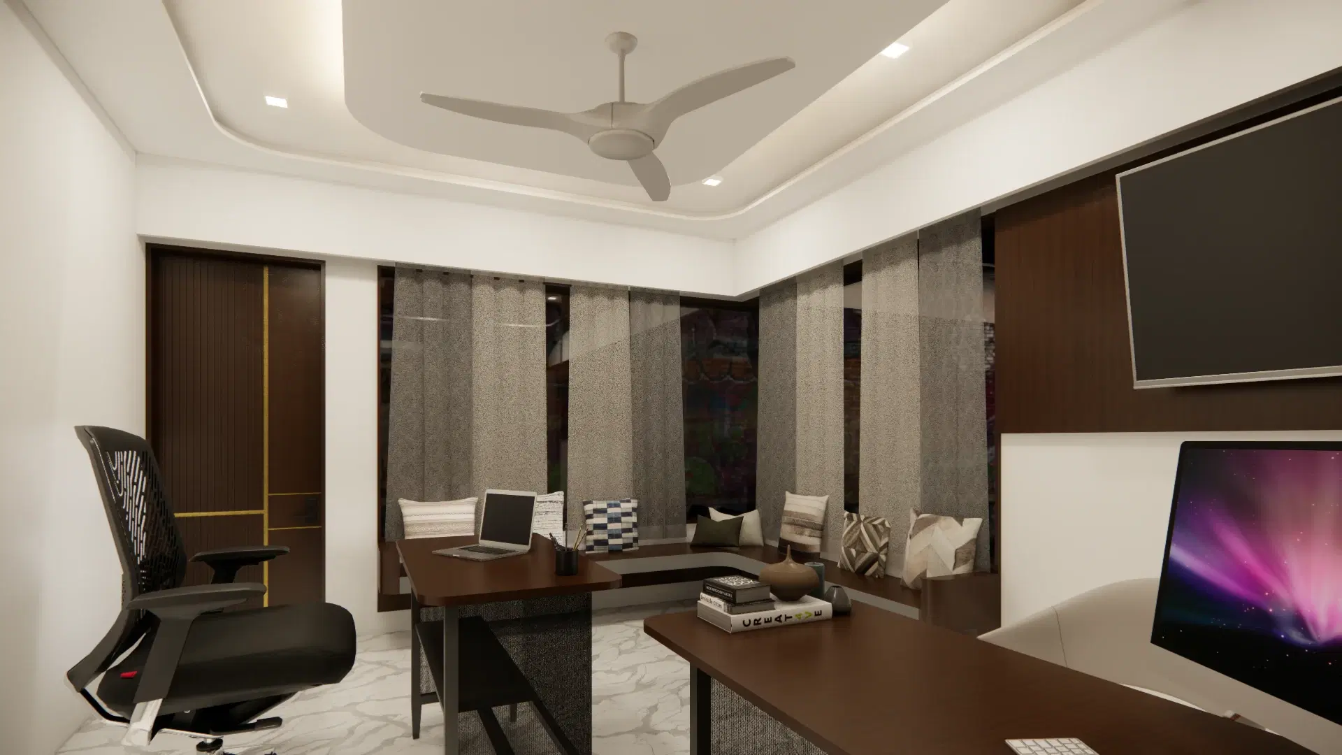 SRM Office, Madaiyur — the office from the doorway, the desk running under the windows with a wall-mounted screen at the far end.