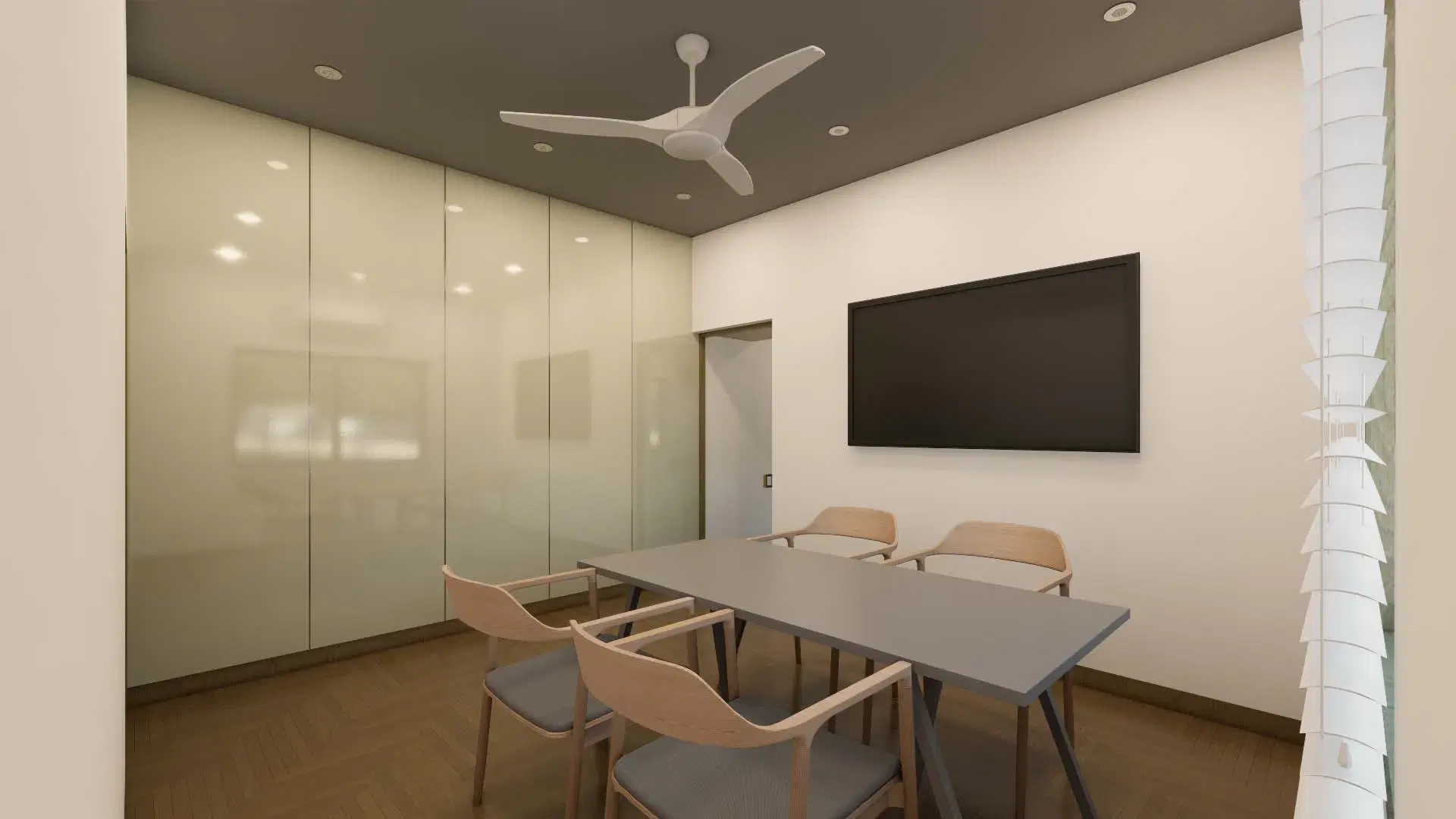SRM Office, Madaiyur — the meeting room, a grey table and timber chairs beside a full-height glazed partition.