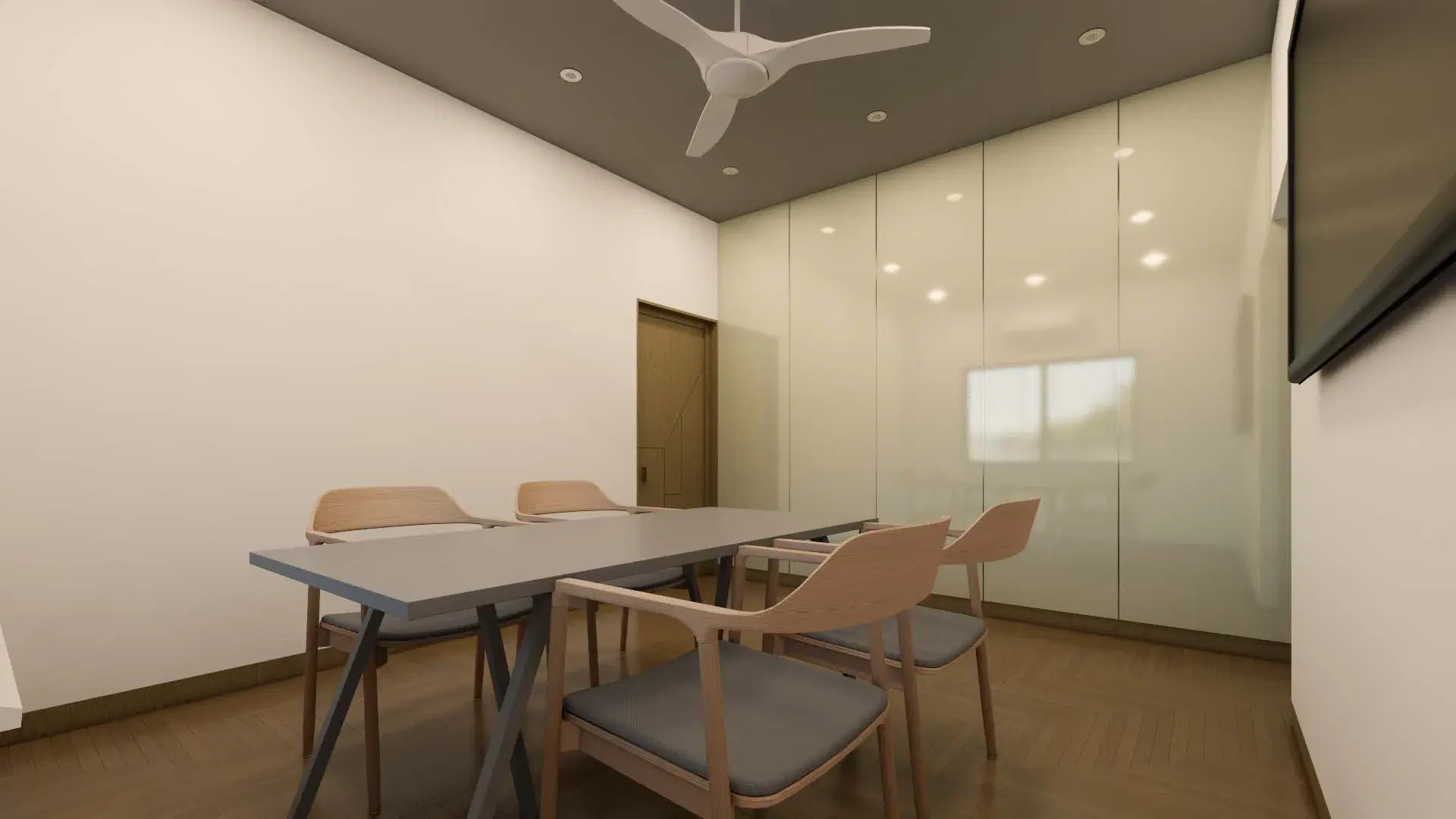 SRM Office, Madaiyur — the meeting room seen from the doorway, the glass partition reflecting the light from the window.