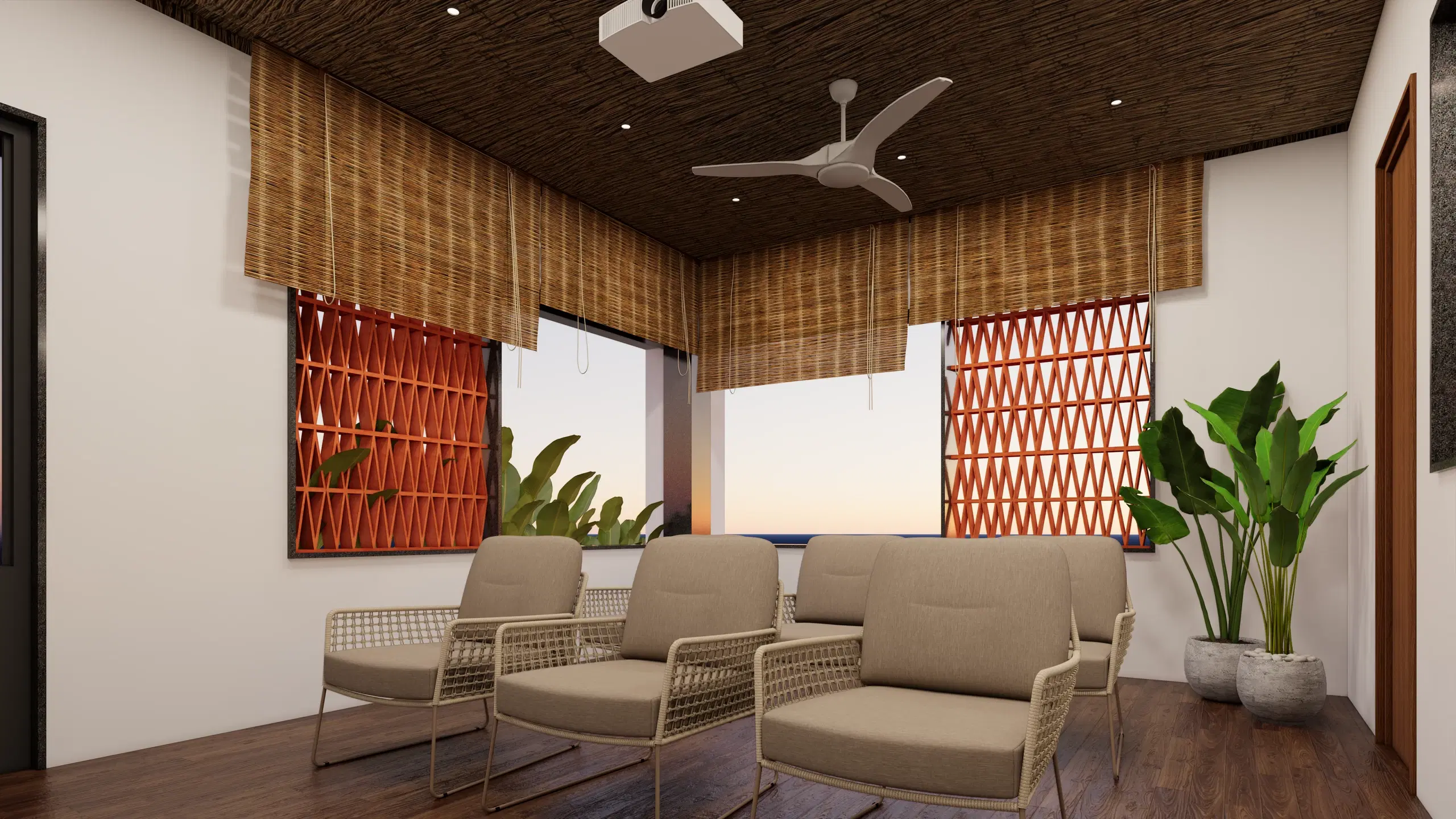 SVH studio apartment, Cantonment — the sitting area under a woven bamboo ceiling, cane armchairs set against red jali screens and planting.